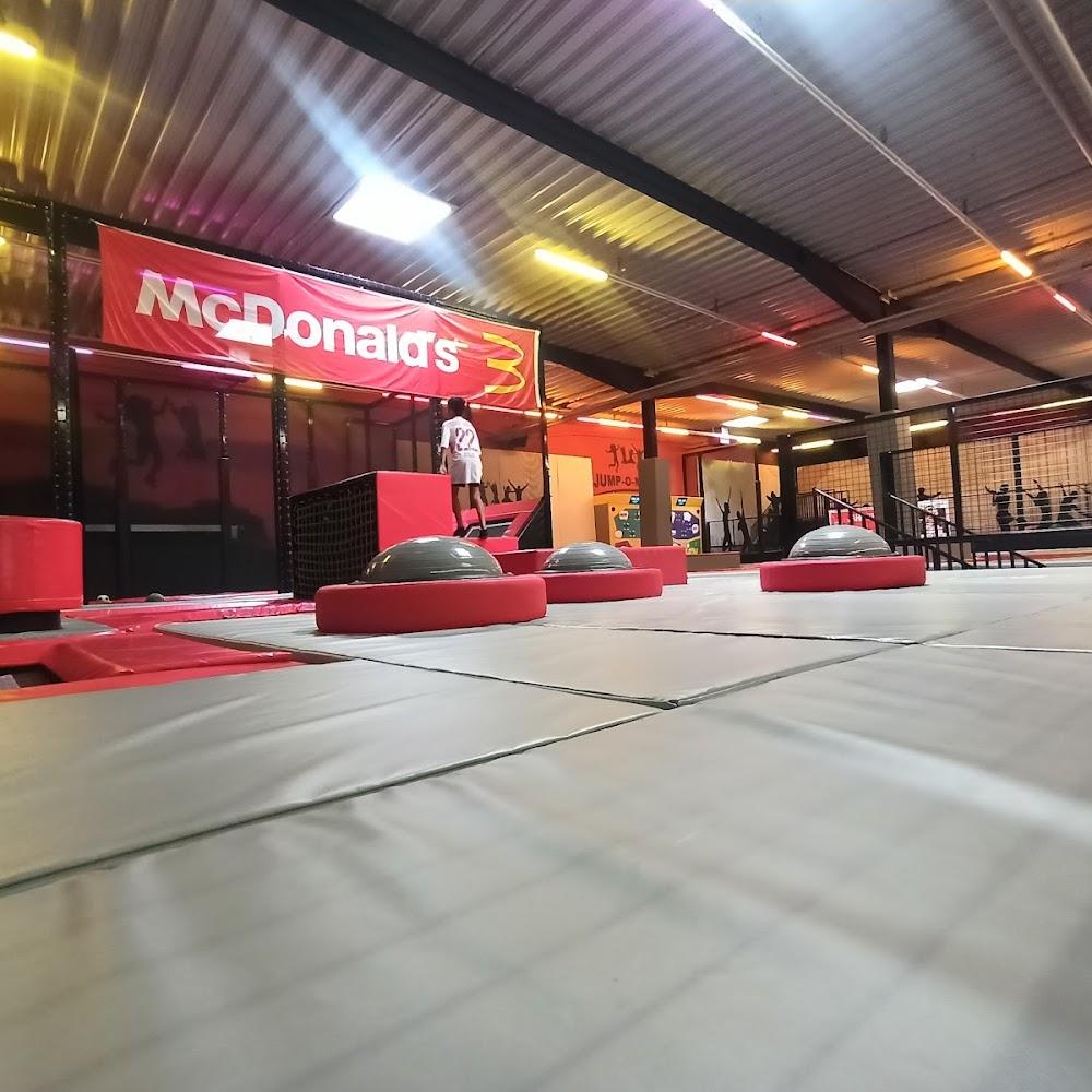 Indoor trampoline park with a McDonald's sign.